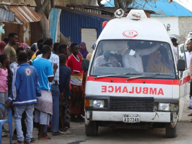 people gather as an ambulance carries the dead body of an unidentified woman killed in an explosion that occurred while revellers were swimming at the lido beach in mogadishu somalia august 3 2024 photo reuters